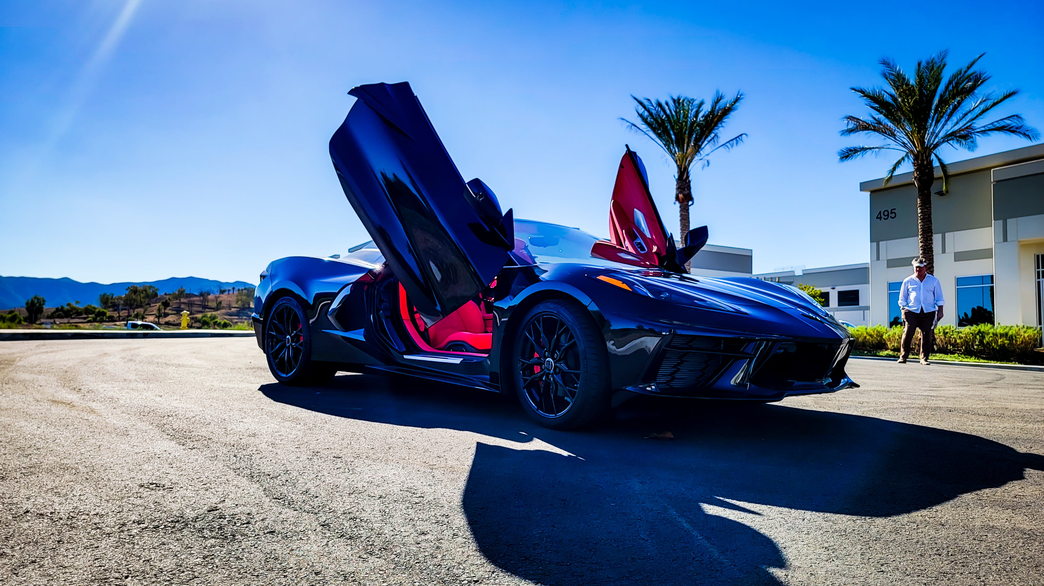 Black and Red Chevrolet Corvette C8 from California featuring Vertical Door conversion kit by Vertical Doors, Inc. AKA "Lambo Doors"