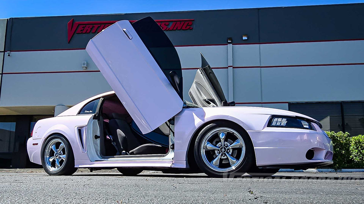 @honey_vibes 4th Gen Ford Mustang getting a few upgrades like a pink color change wrap, lambo door kit, carbon fiber spoiler and much more, can’t wait to see the finished car, as always lambo door kit by Vertical Doors, Inc.