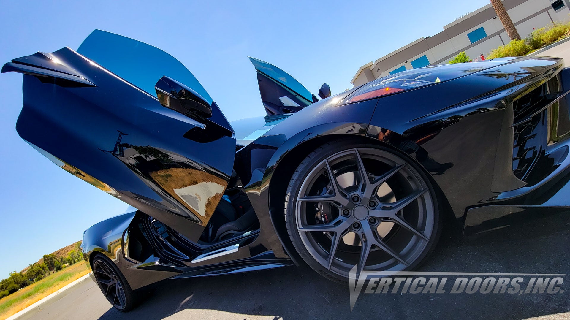 Black Chevrolet Corvette C8 from California featuring Vertical Door conversion kit by Vertical Doors, Inc. AKA "Lambo Doors"
