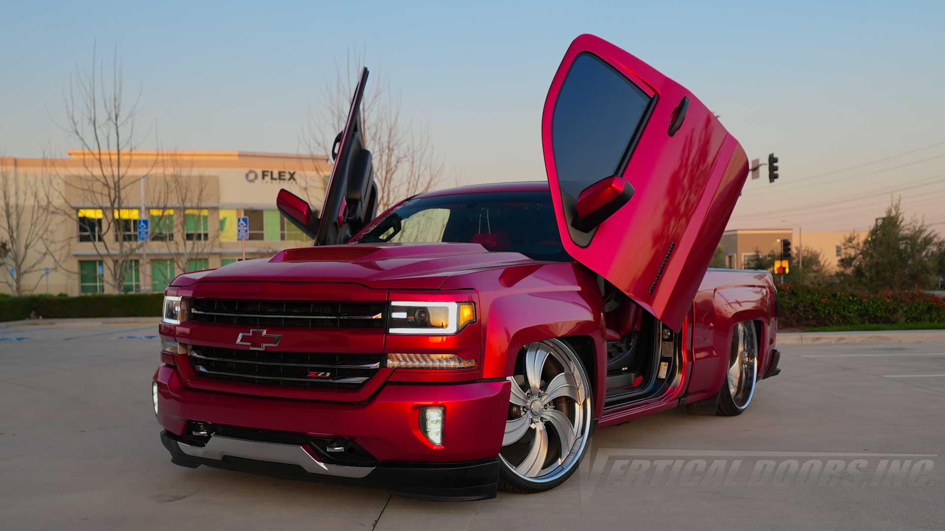 @la.mamawhiski Custom Chevrolet Silverado truck in California with Vertical Doors Inc. Lambo Door Conversion Kit, lifted suspension, oversized wheels, and show-quality finish, known as “La Mamawhiski”, 