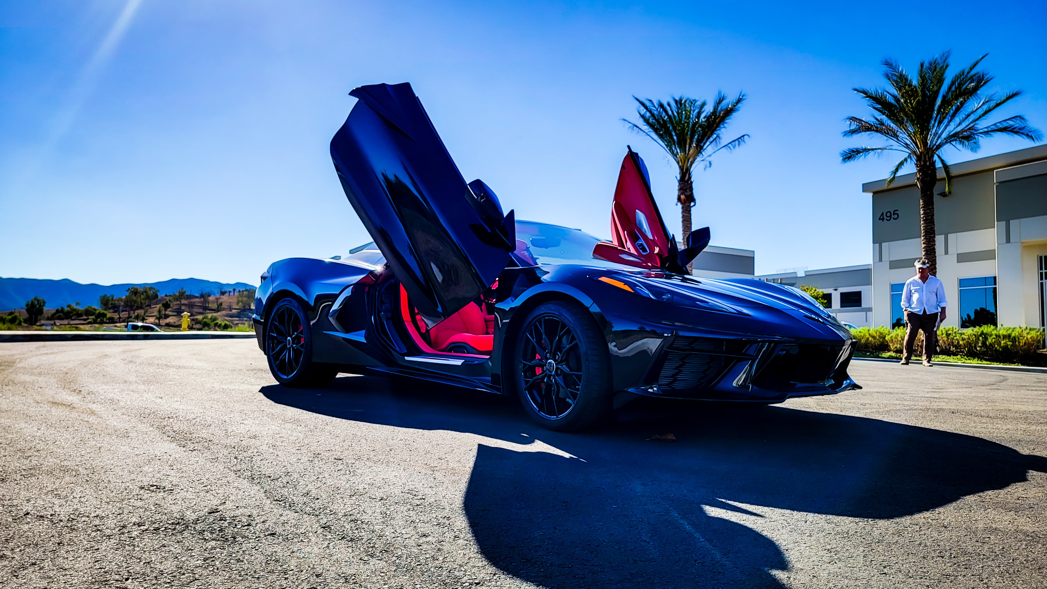 Black and Red Chevrolet Corvette C8 from California featuring Vertical Door conversion kit by Vertical Doors, Inc. AKA "Lambo Doors"