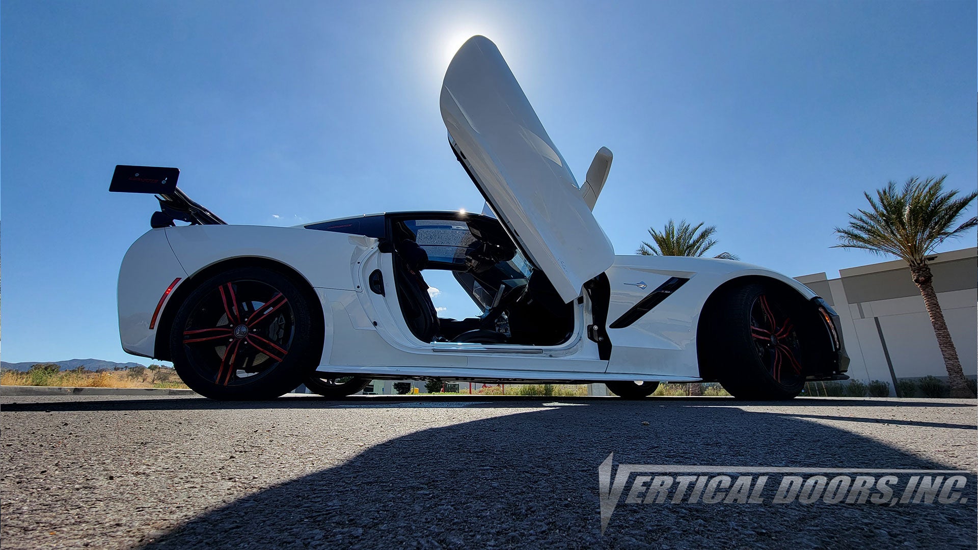 White Chevrolet Corvette C7 from California with vertical lambo door conversion kit by Vertical Doors, Inc.