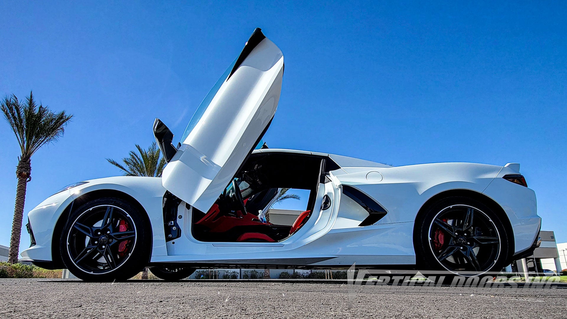 Arctic White Chevrolet Corvette C8 from California featuring Vertical Doors, Inc. door conversion kit. AKA "Lambo Doors"
