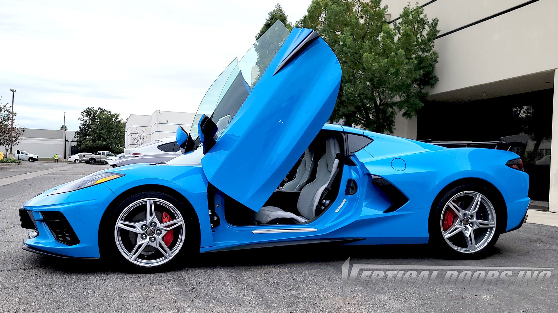 Rapid Blue Chevrolet Corvette C8 from California featuring vertical lambo door conversion kit by Vertical Doors, Inc.