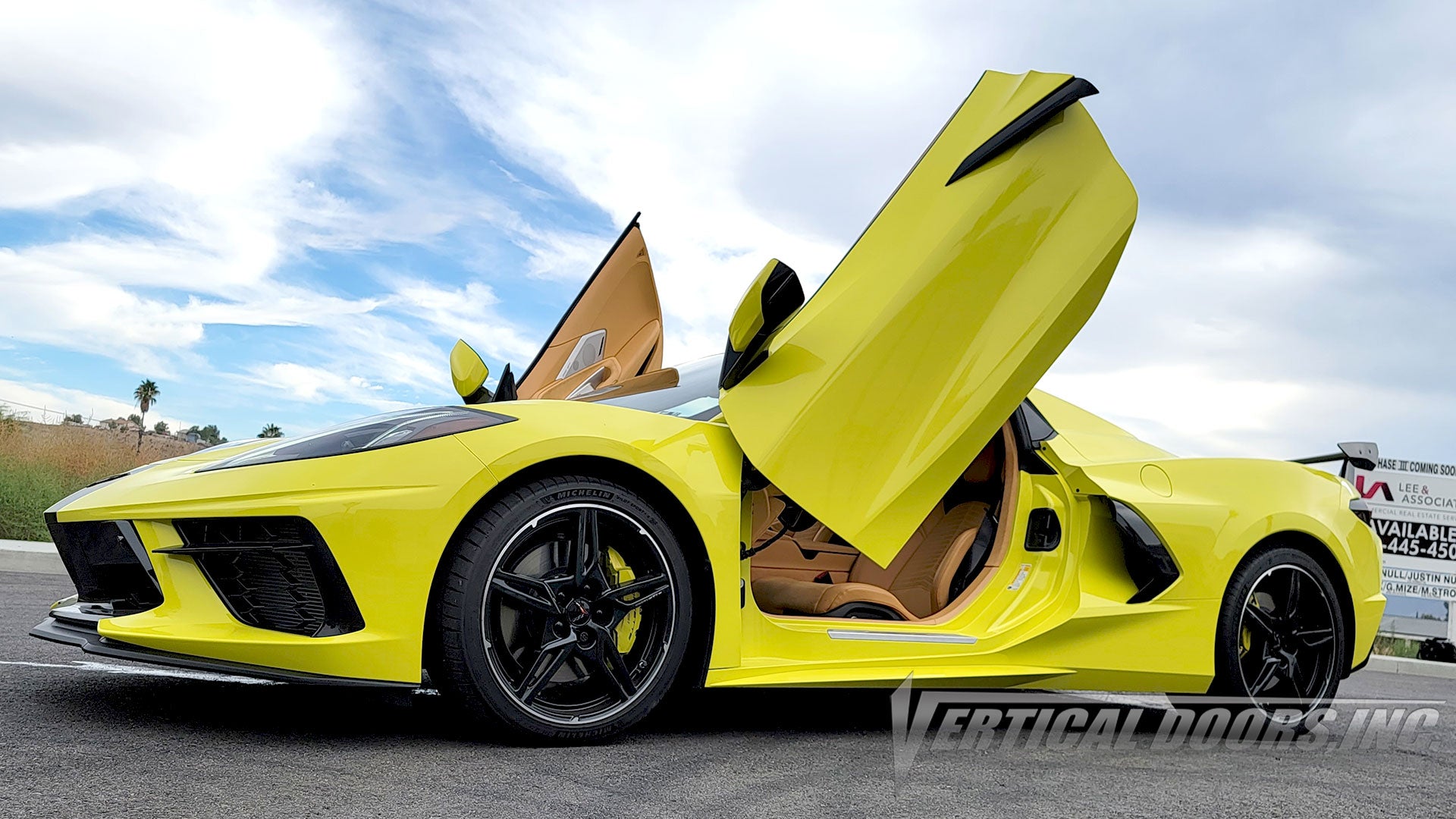 Accelerate Yellow Corvette C8 with raised vertical doors, a tan interior and black wheels