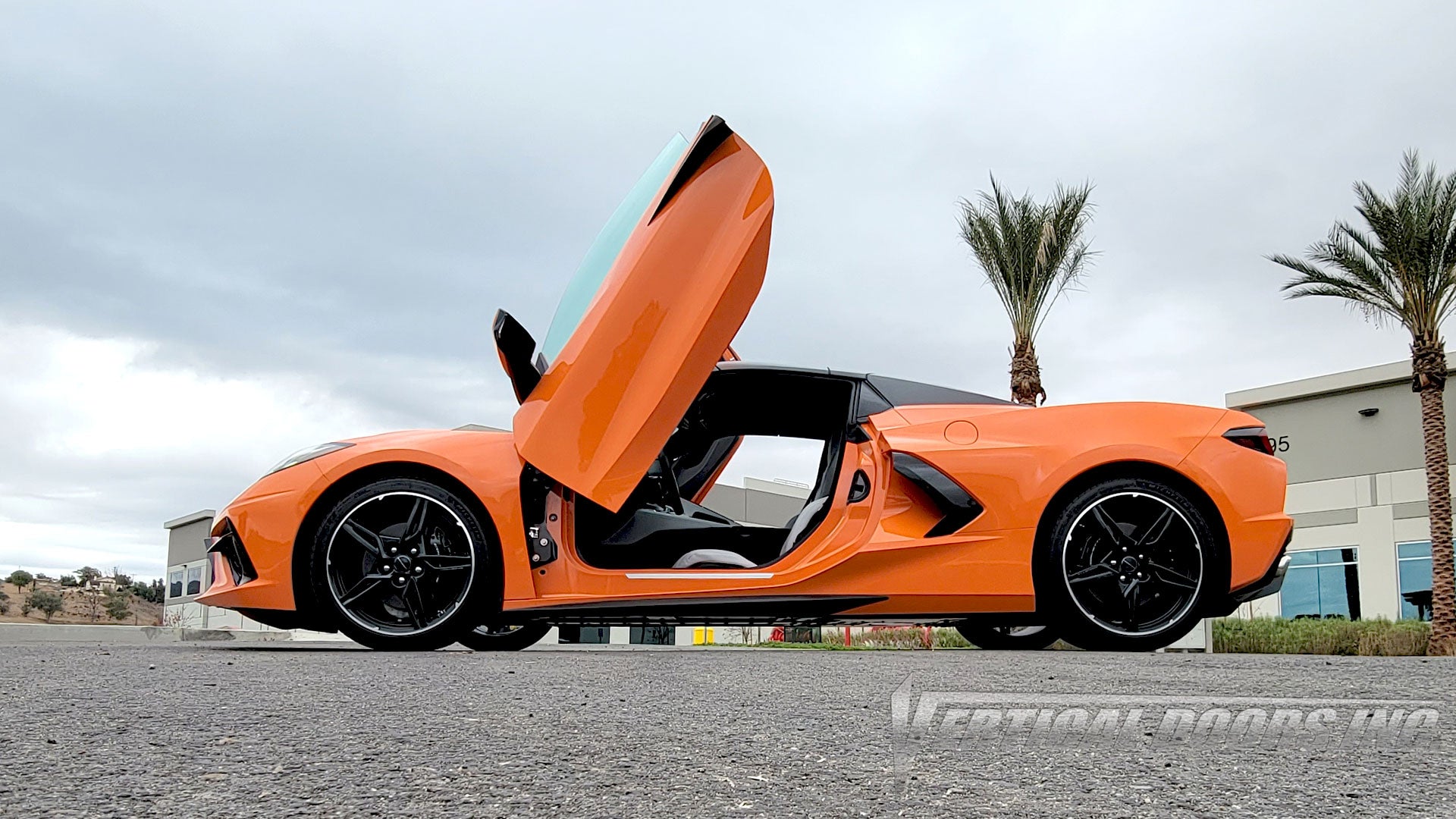 Sebring Orange Chevrolet Corvette C8 from California featuring Vertical Doors, Inc., vertical lambo door conversion kit.