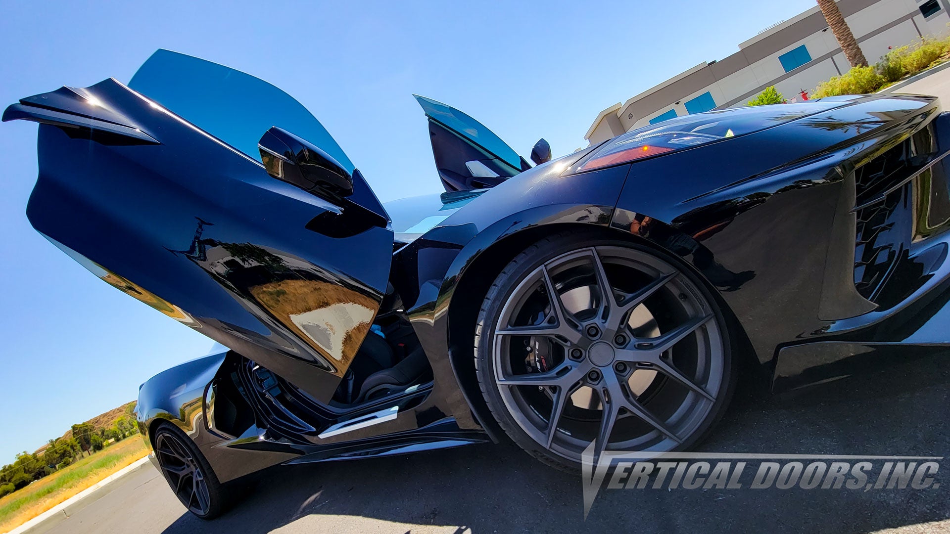 Black Chevrolet Corvette C8 from California featuring Vertical Door conversion kit by Vertical Doors, Inc. AKA "Lambo Doors"