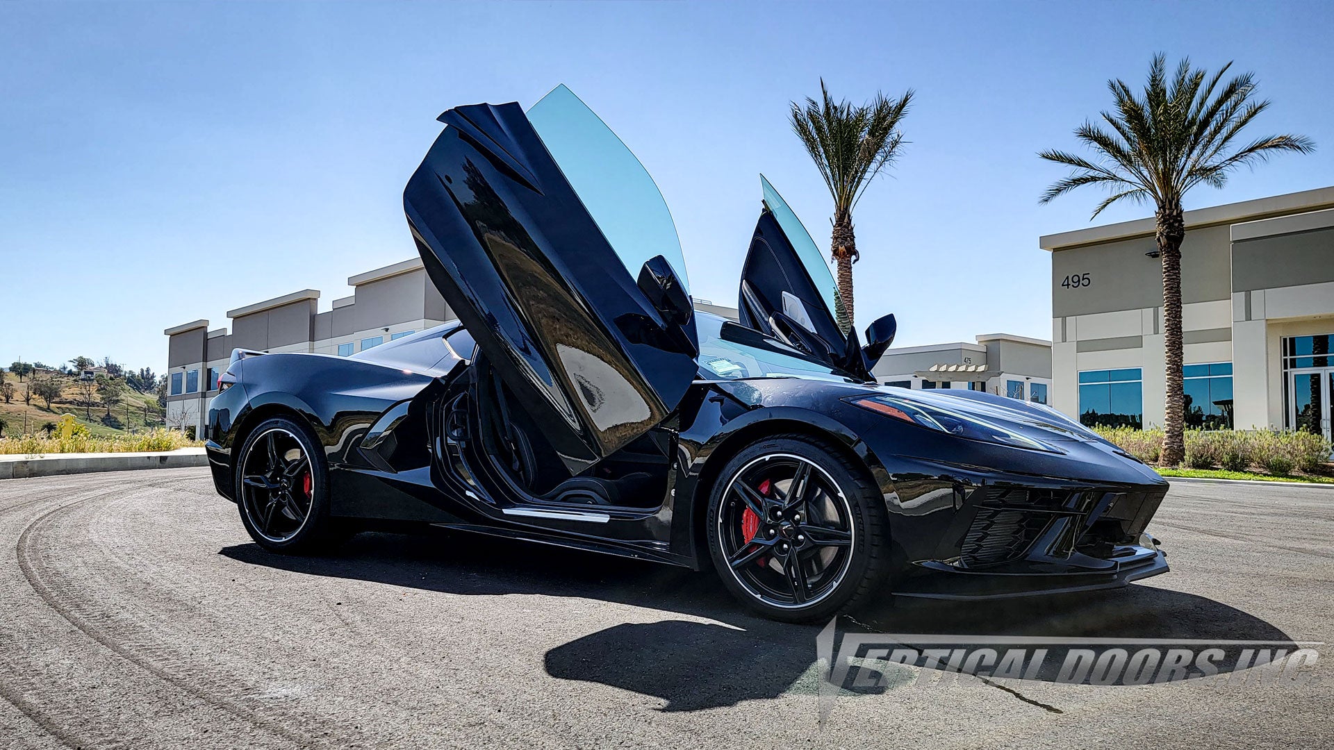 Black Chevrolet Corvette C8 from California featuring vertical lambo door conversion kit by Vertical Doors, Inc.