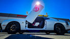 White Ghostbusters themed Dodge Challenger from 909 Mopars with Vertical Doors, Inc. Lambo door kit open in front of the Vertical Doors, Inc. Lake Elsinore, California headquarters.